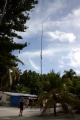 Radio antena held up in the middle of town.